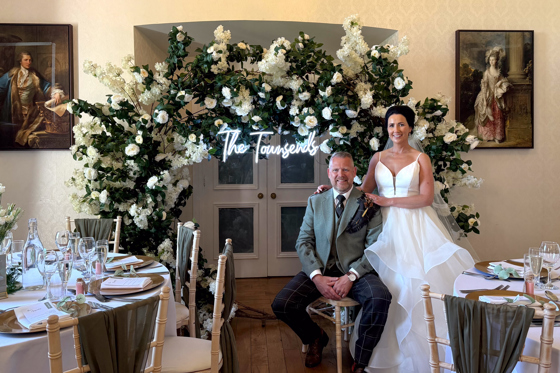 Couple Posing by Floral Decor by Let's Do It Creative